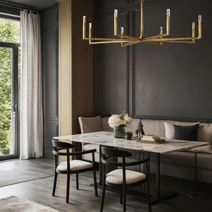 Modern dining room with marble table, chairs, and chandelier.