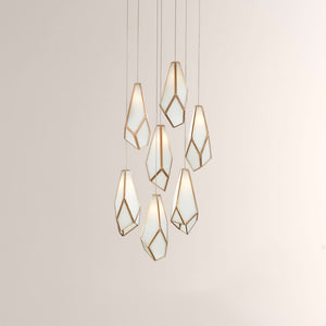 Modern pendant light with geometric glass shades on a neutral background